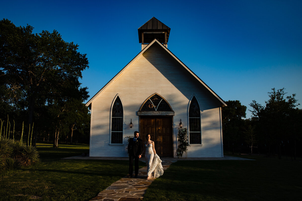 Bride and groom walk out of chapel at La Bonne Vie Ranch in Fredericksburg, TX