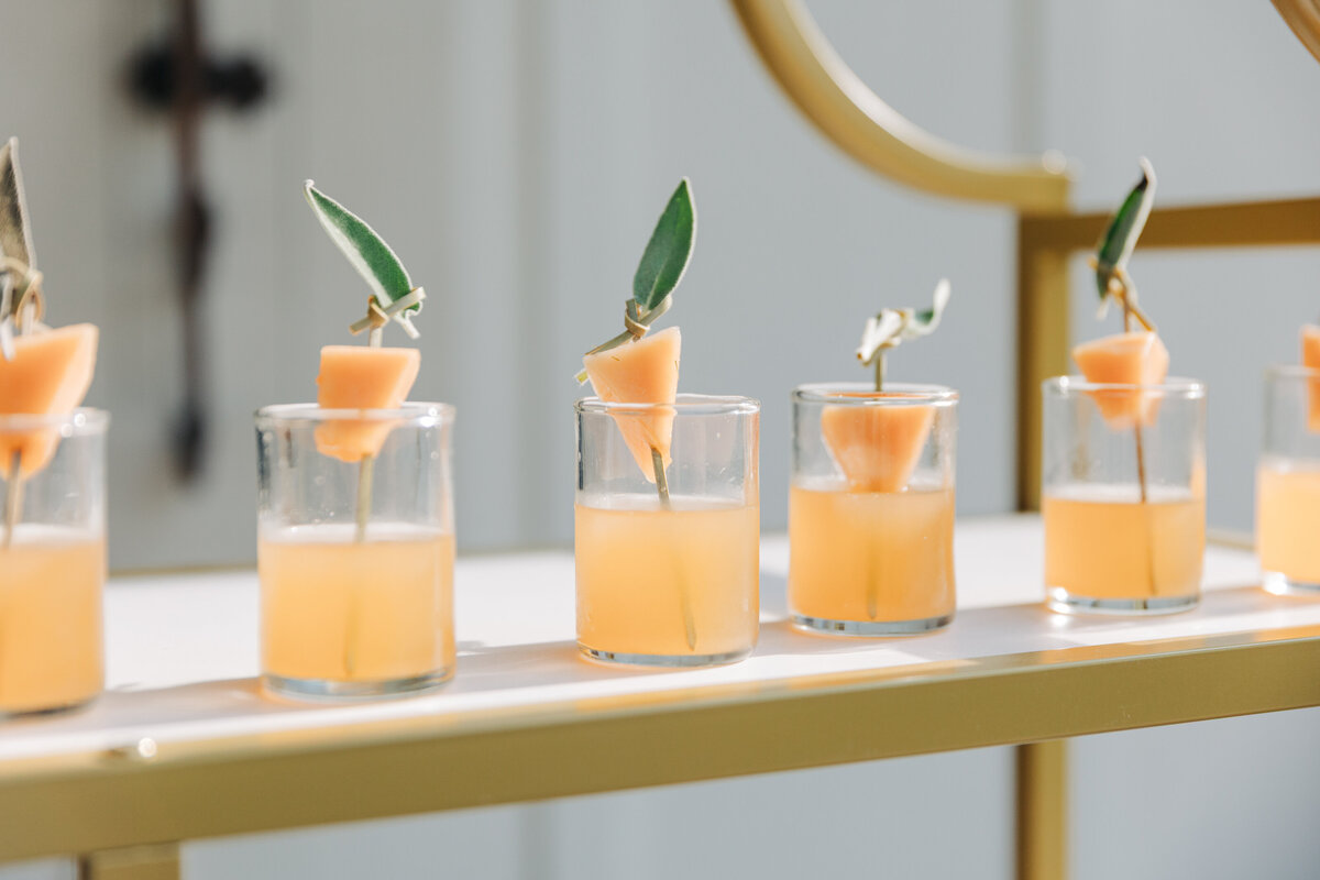 Refreshing signature wedding cocktails served in clear glasses with cantaloupe garnish and fresh sage, displayed at The Seclusion in Virginia.