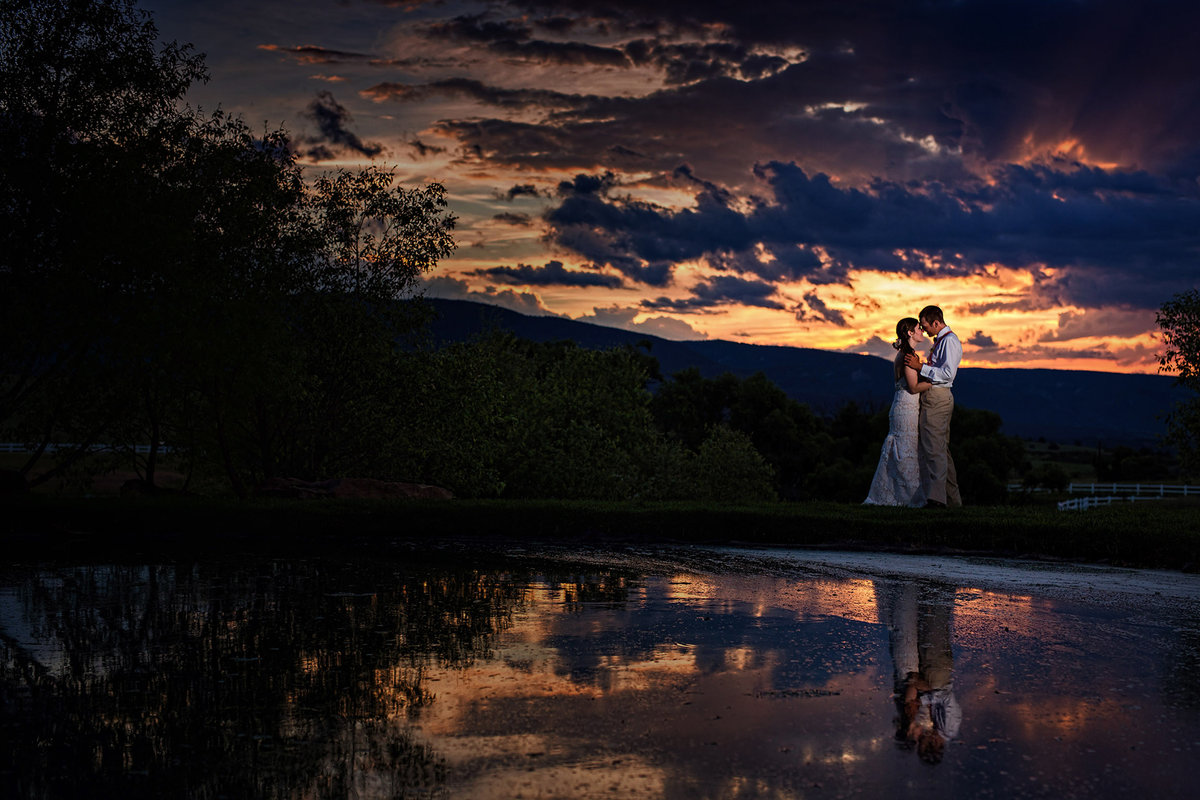 amazing sunset with bride and groom in lake