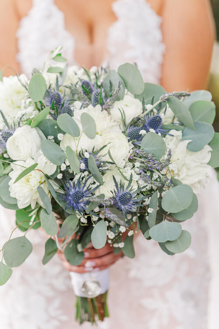 Close up of a blue, white and green bridal bouquet in Arkansas.