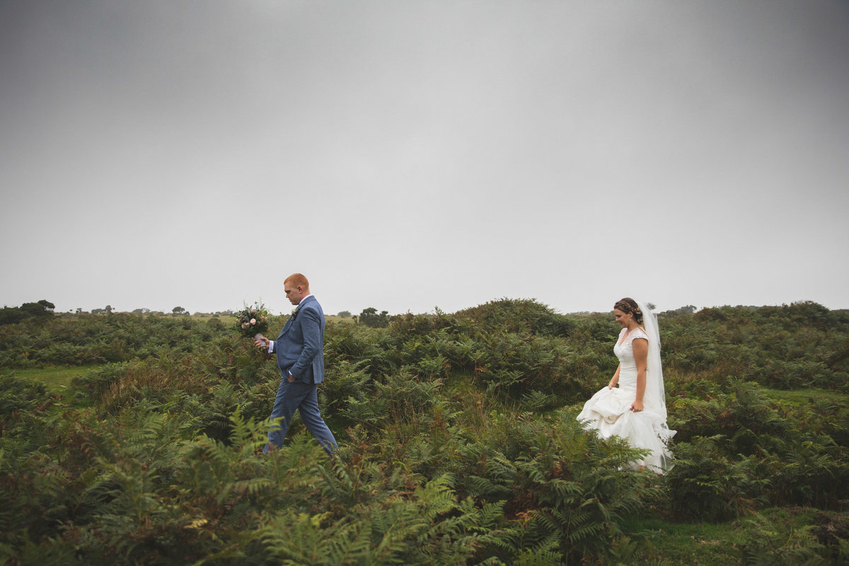 Bride and Groom walking on Bodmin Moor near The Green in Cornwall