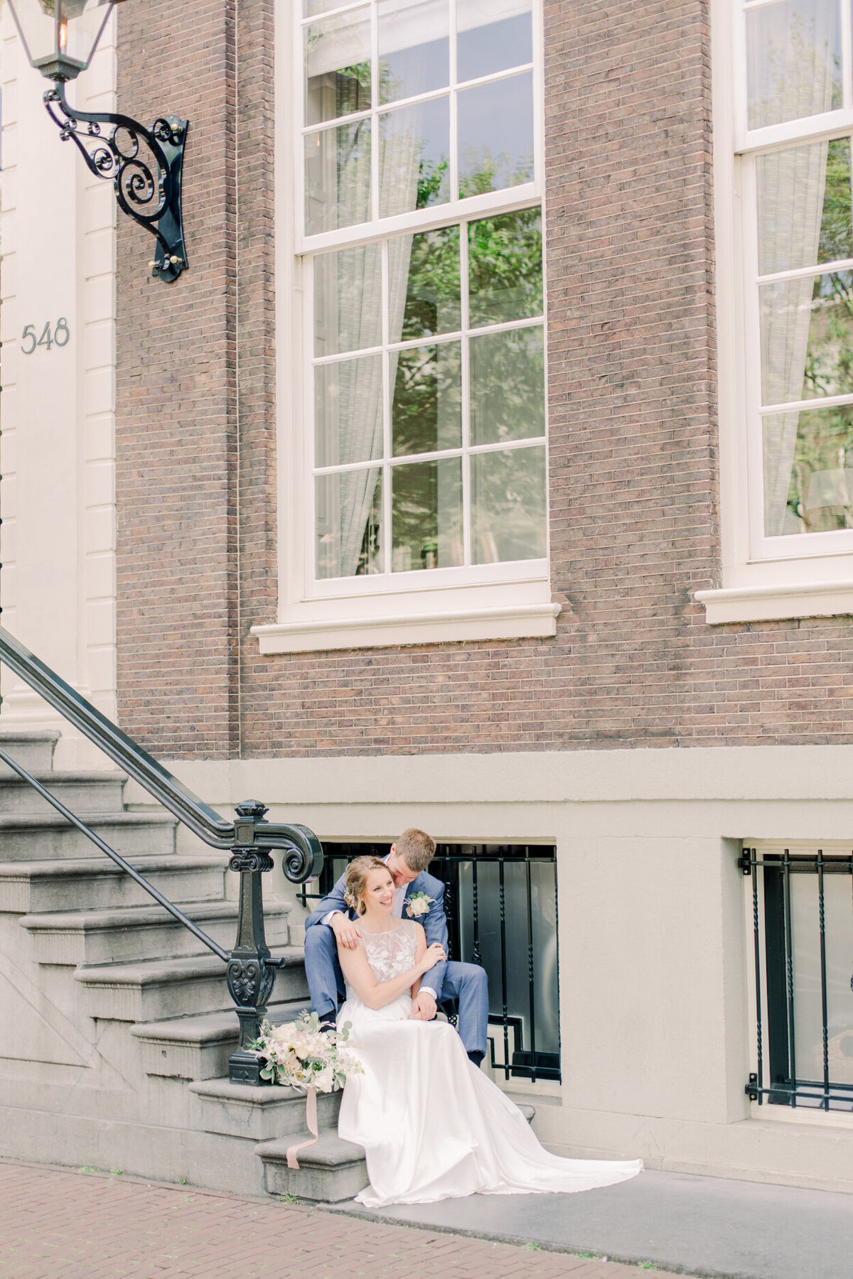 Wedding portrait of the bride and groom in the streets of Amsterdam for their city elopement for a photoshoot organized by Lovely & Planned