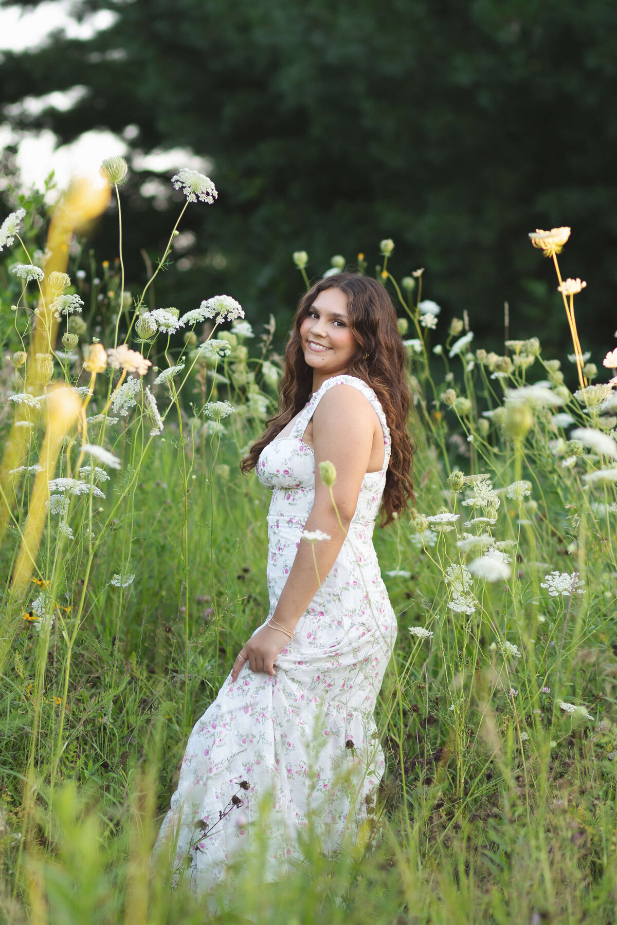 girl in white dress by white flowers