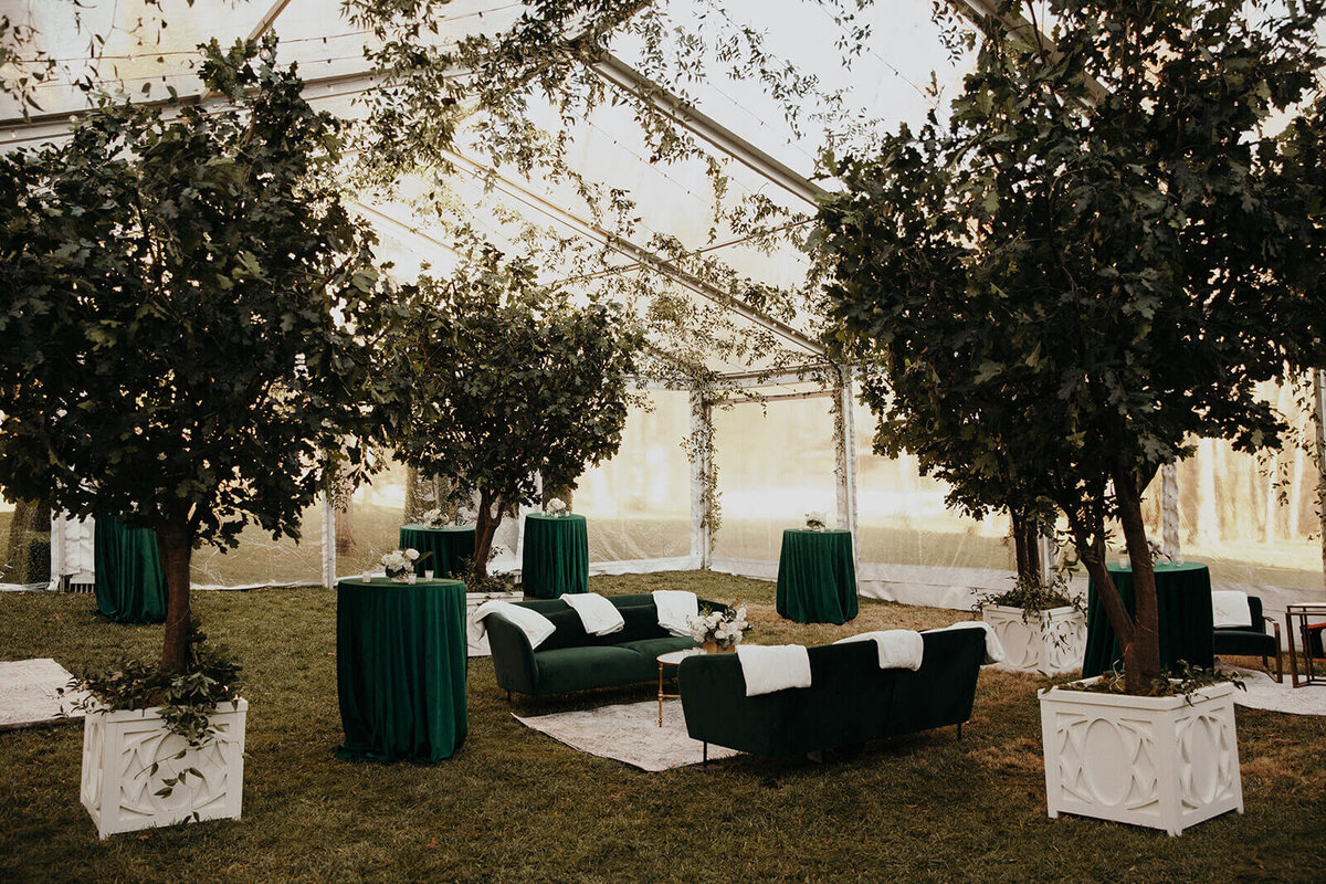 emerald green velvet linens and sofas in clear top tent cocktail hour