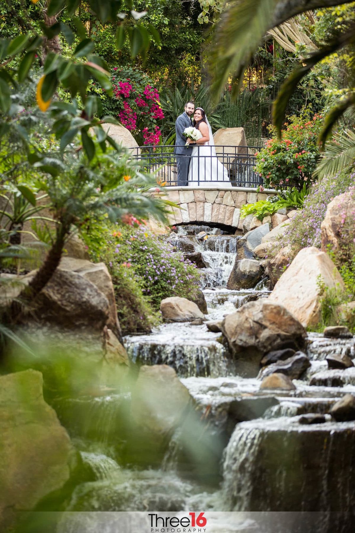 Couple standing in beautiful garden area of wedding venue