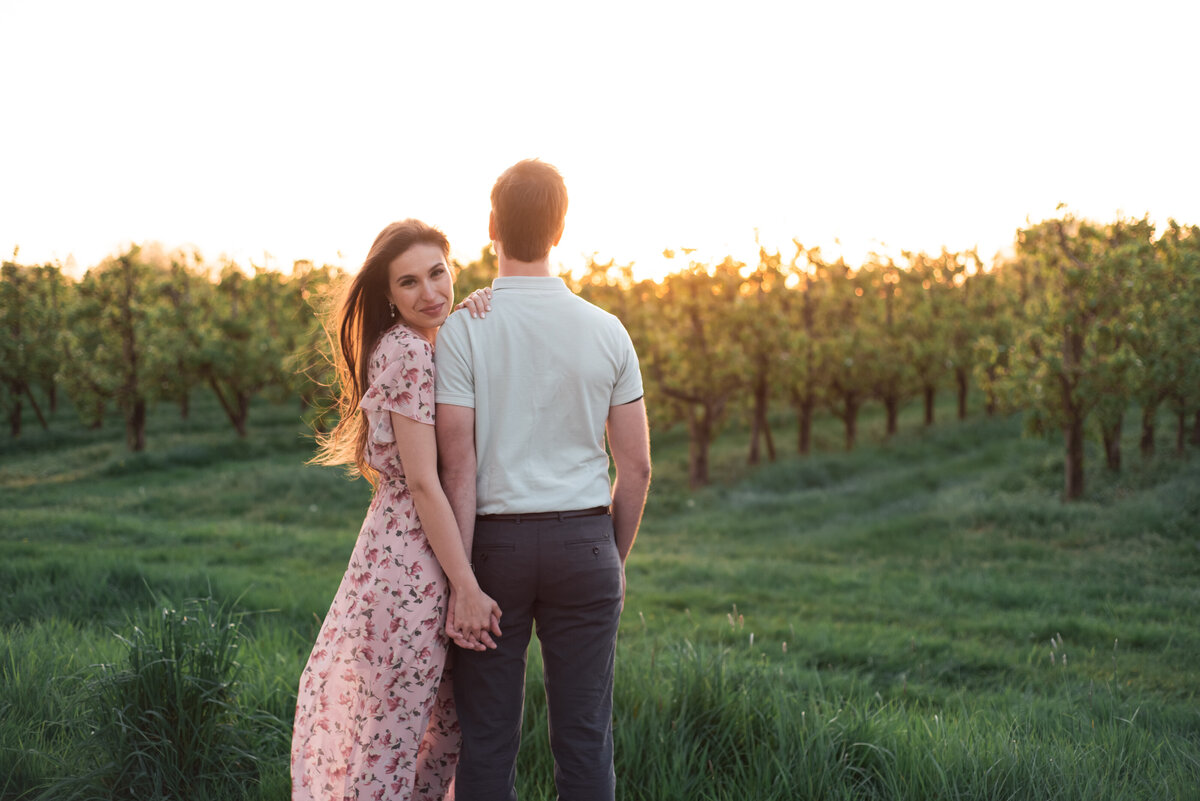 Couple standing in vineyard in Tuscany