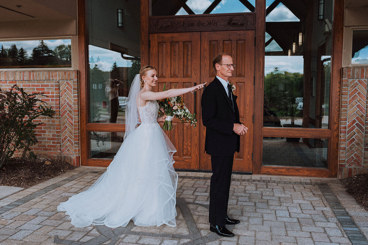Bride walking up and tapping dad on shoulder for first look