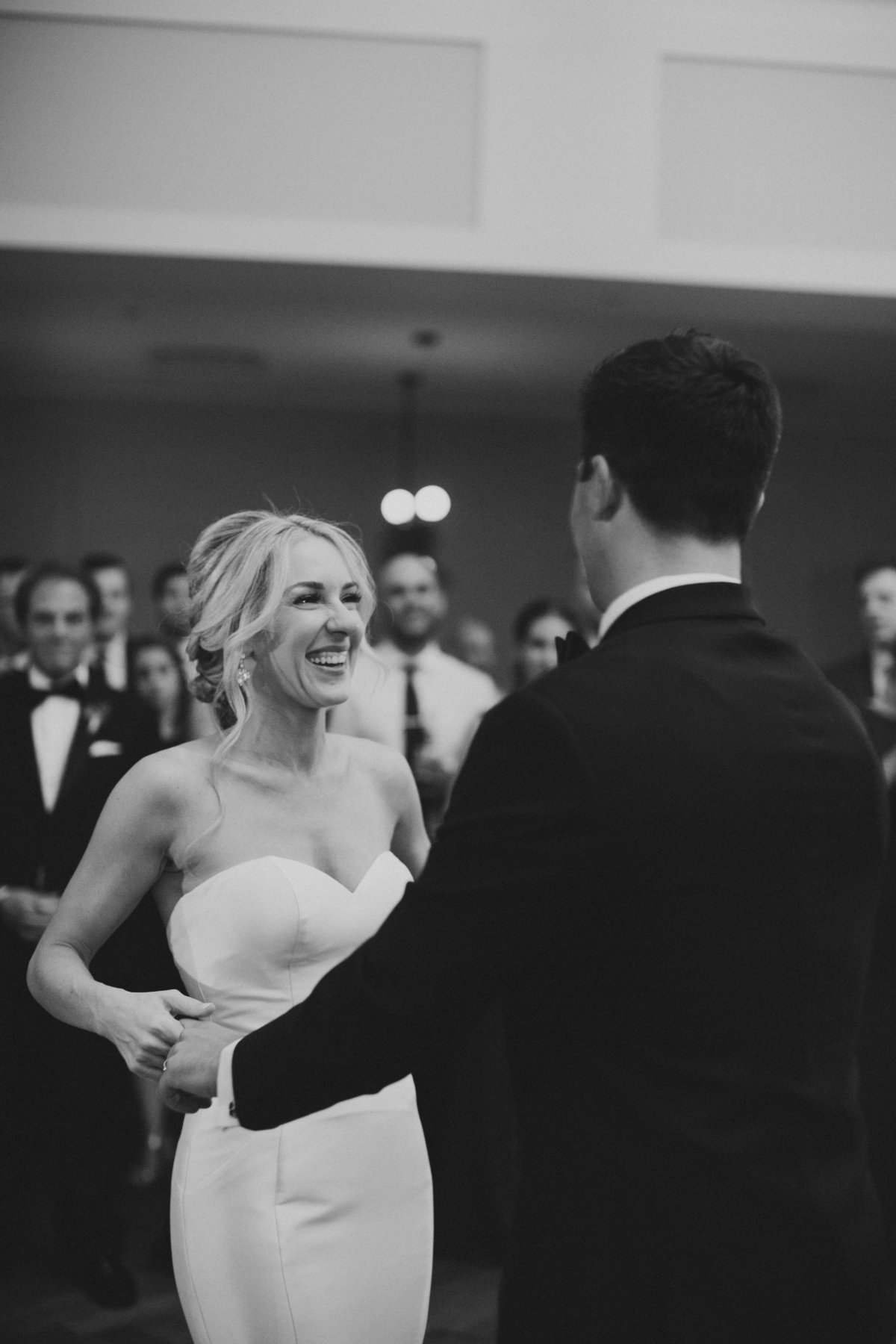 bride and groom dancing in black and white portraits