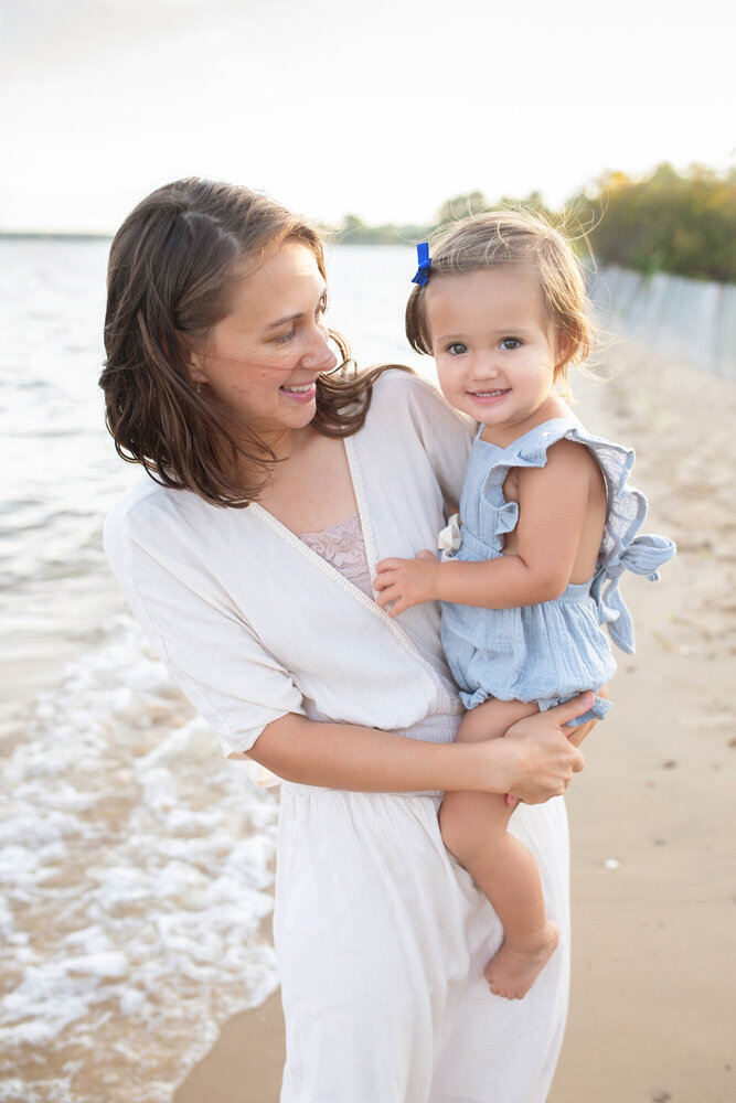 Family session of little girl and mother at the beach