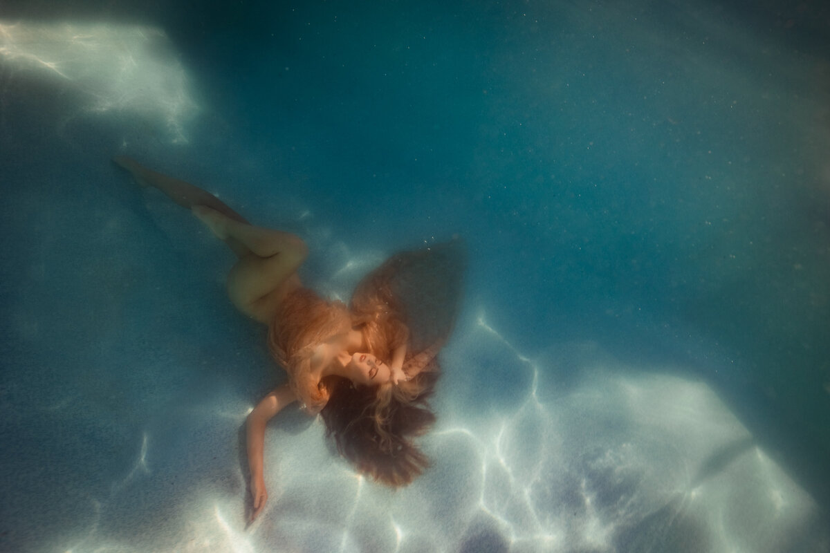 underwater portrait of a women in a pool
