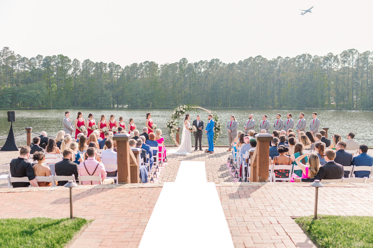 A wedding ceremony on the Neuse River with their family and friends in June by JoLynn Photography, a North Carolina wedding photographer