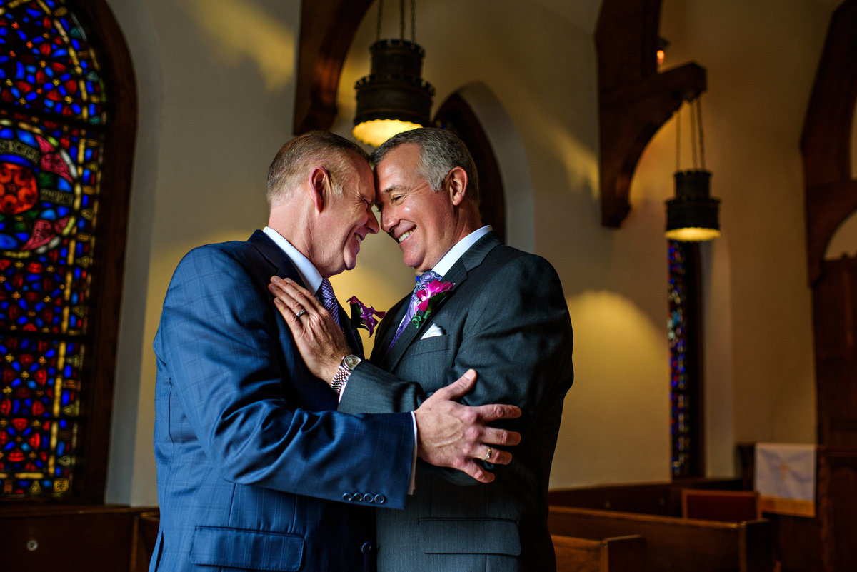 Two grooms share in the excitement of their same sex wedding.