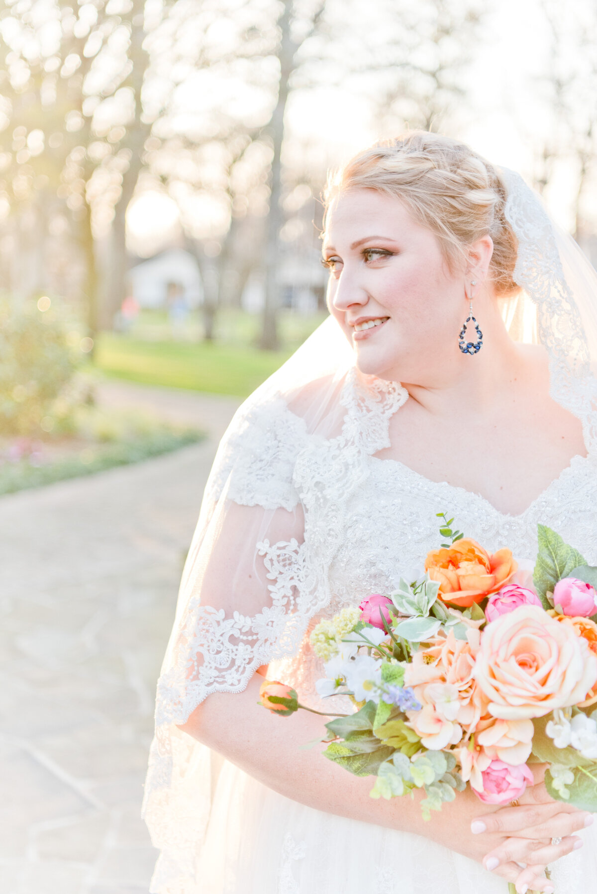 Bride looking into Fort Worth sunset while holding colorful vibrant bouquet