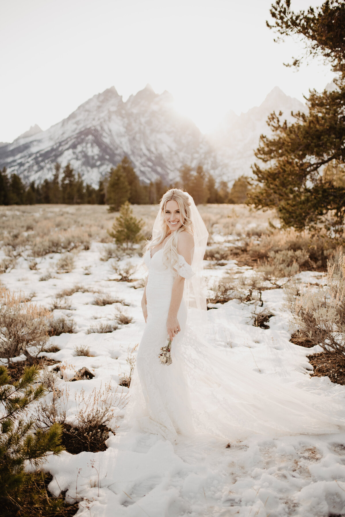 Jackson Hole Photographers capture bride smiling after winter elopement