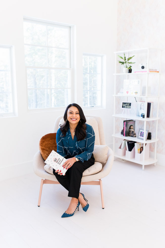 Female entrepreneur in office with book