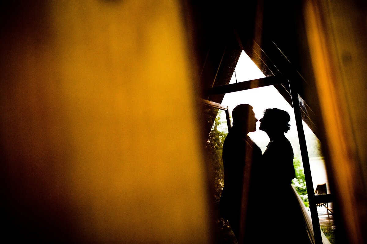 A couple portrait in silhouette during a Camp Wandawega wedding.