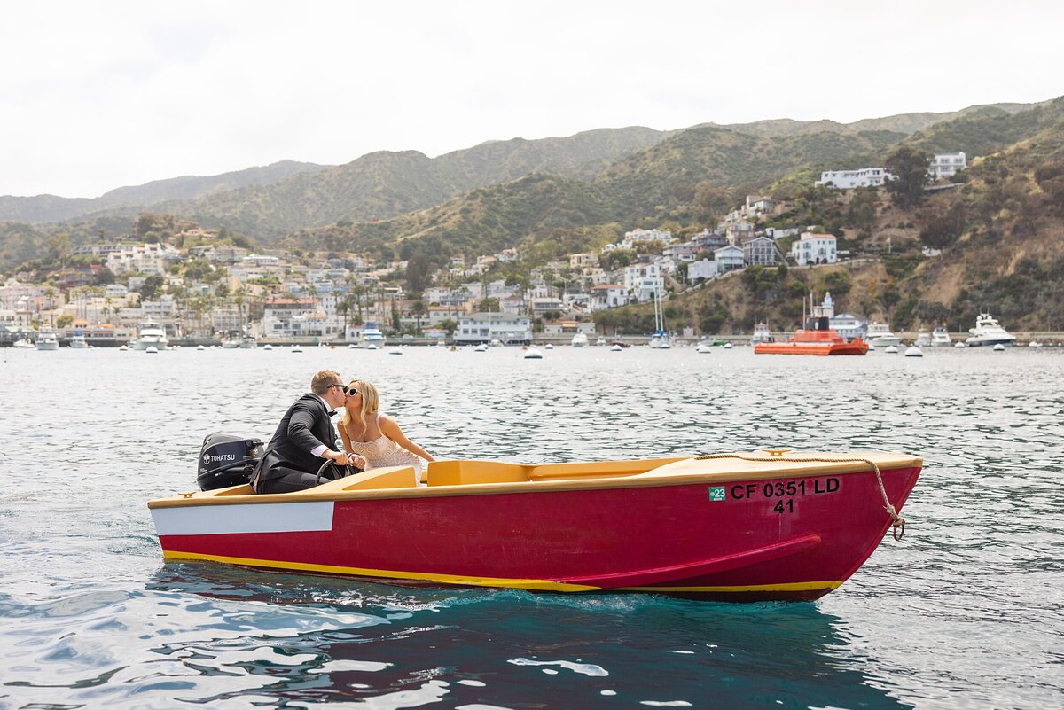 bride and groom kiss on a boat during their Catalina Island elopement celebration