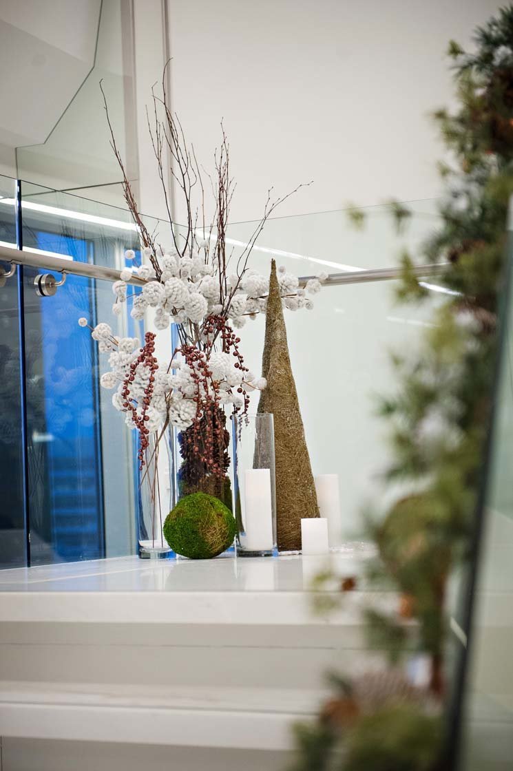 holiday decor for corporate party with cones, sparkle branches, and garlands