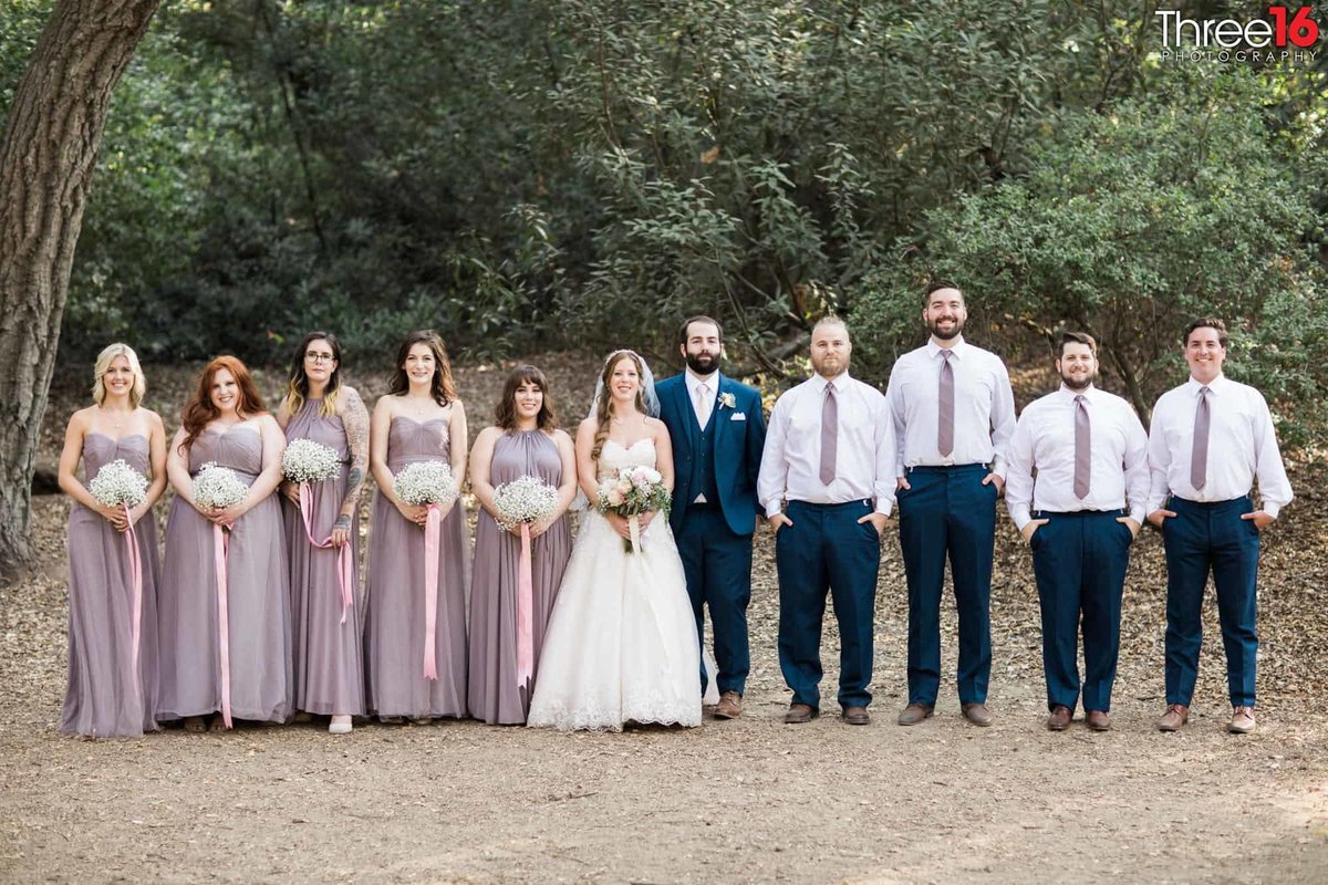 Bridal party poses for photos with the newly married couple