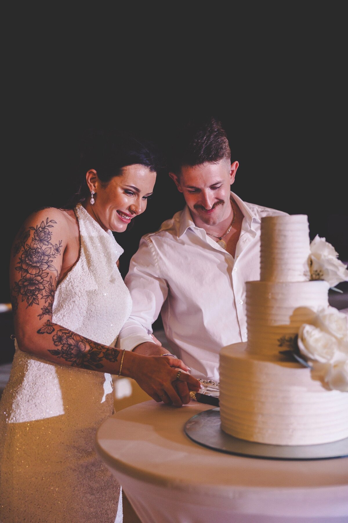 Bride and groom cut cake at wedding in Cancun