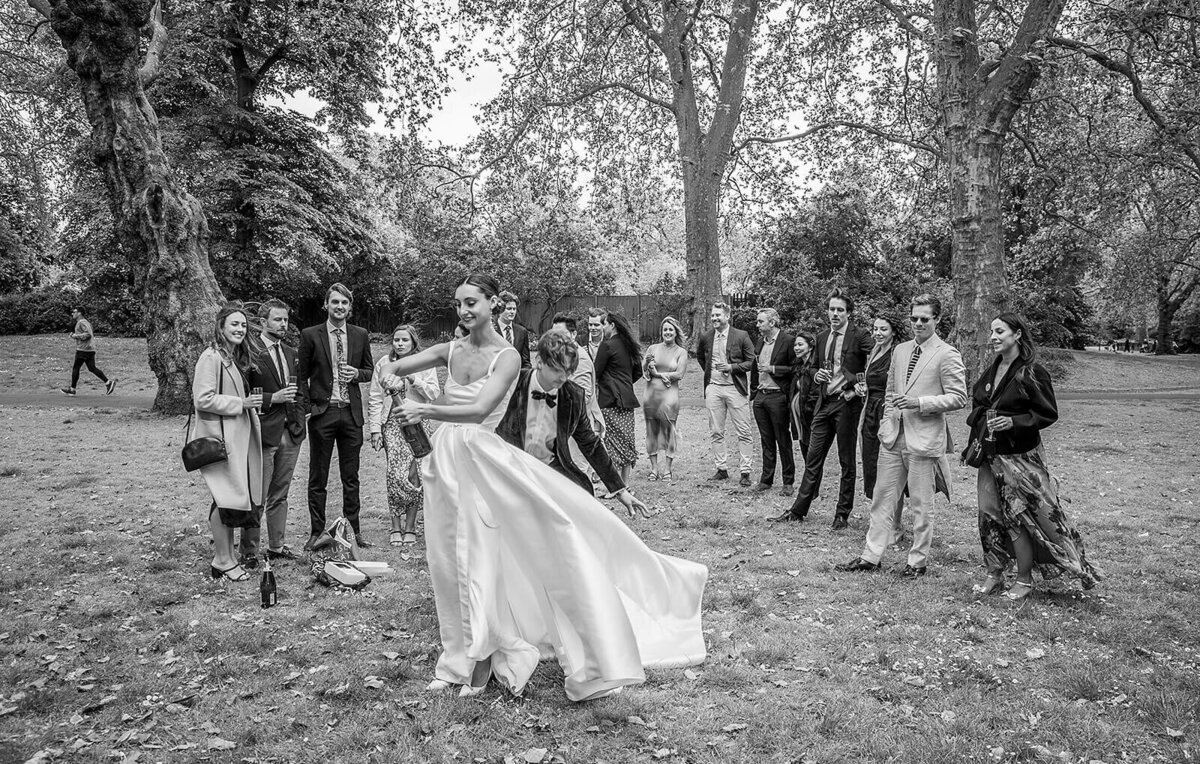 Bride serves champagne in Chelsea park