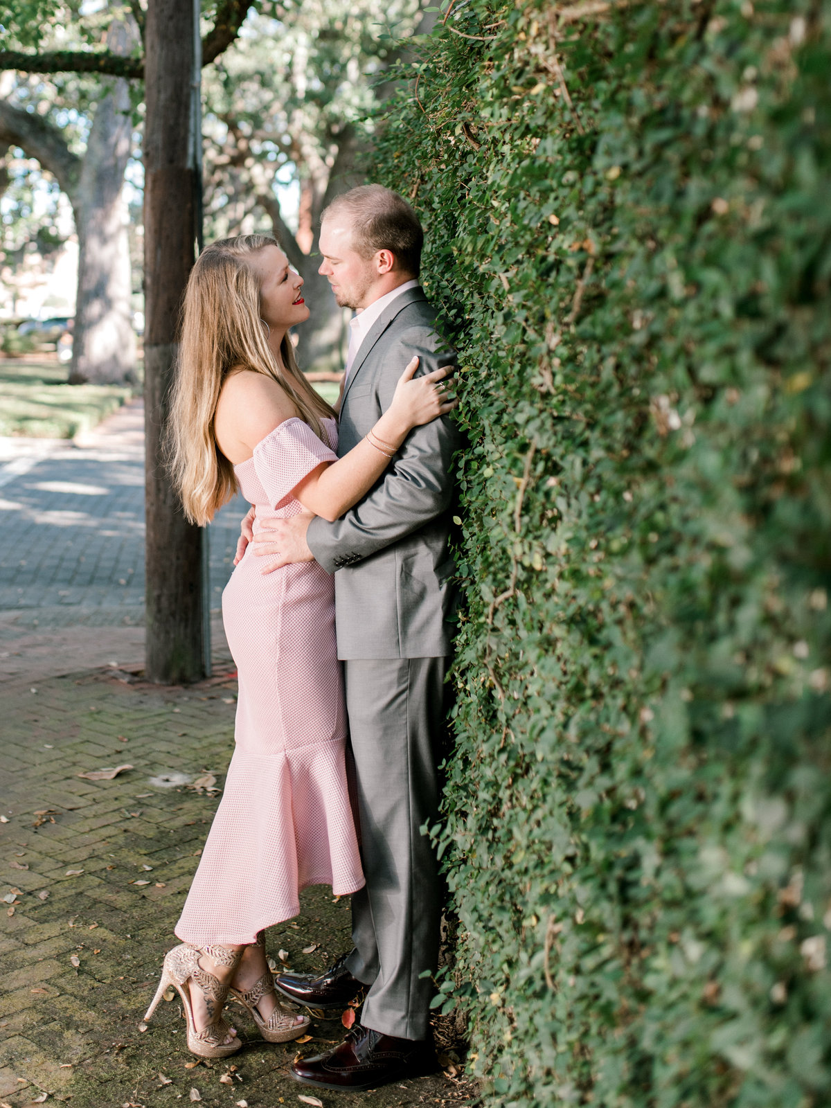 Couple leans against Ivy wall