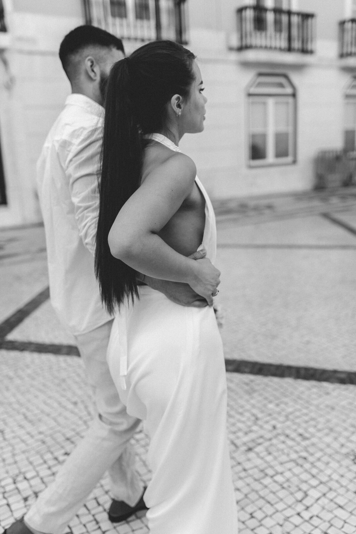 Tammie and Salvador walking in the streets of Lisbon captured by Sarah Hurja Europe destination wedding photographer.