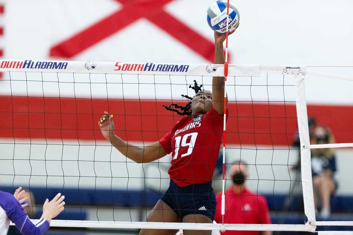 University of South Alabama volleyball play at the net.