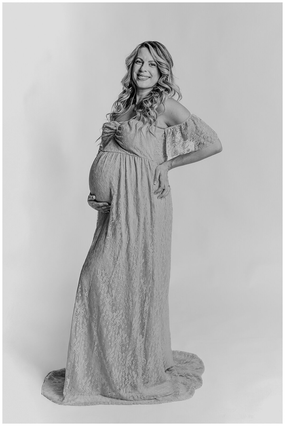 Mom to be showing off her beautiful baby bump in a cute top and jeans during a maternity photoshoot in studio in Wexford PA