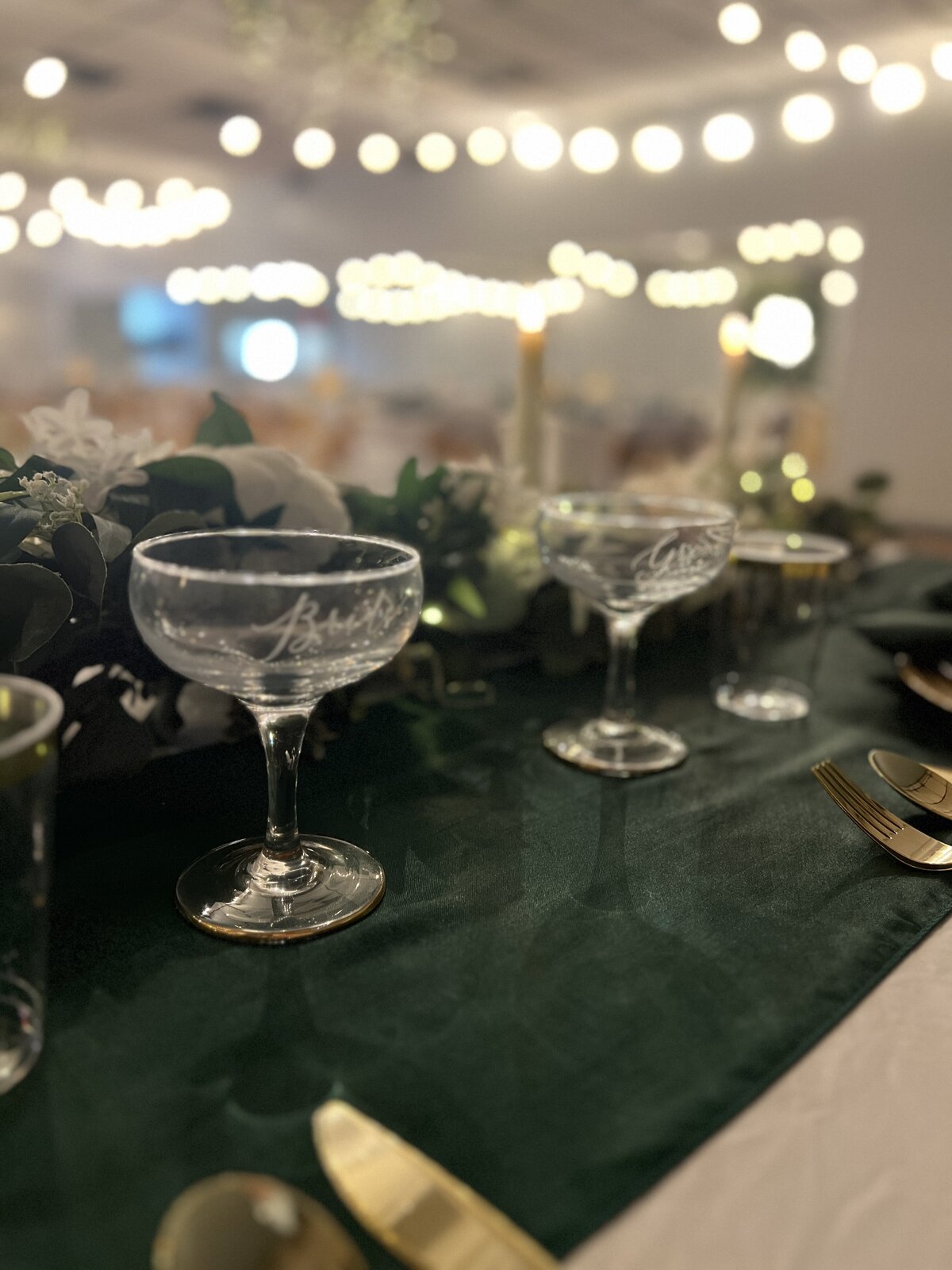 Custom glass martini glasses for the bride and groom, included in our decor packages and affordable venue packages at The District Clearwater event venue - Raise a toast in style on your special day