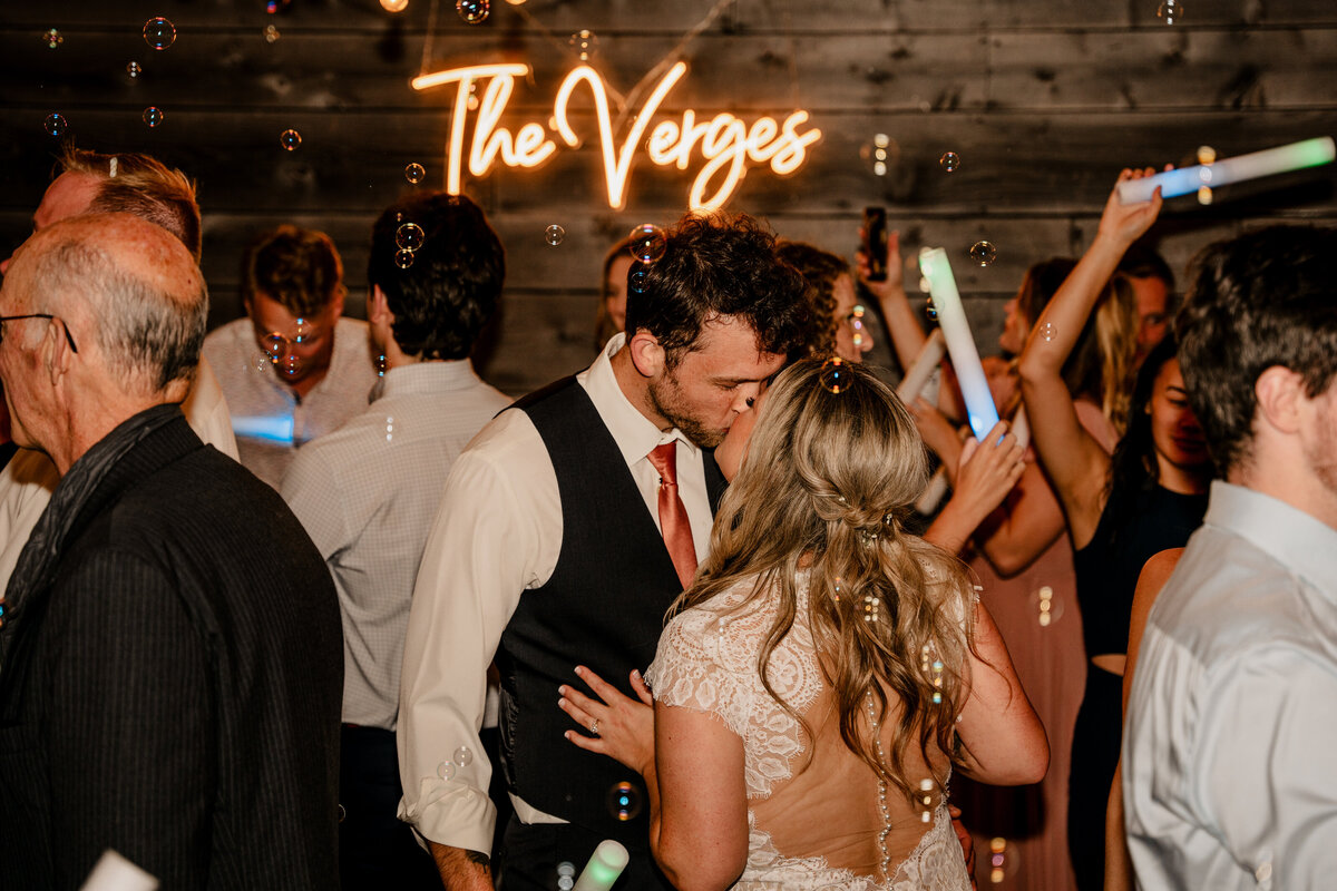 At Brown Family Homestead in Leavenworth, Washington, the married couple enjoys a kiss on their dance floor.