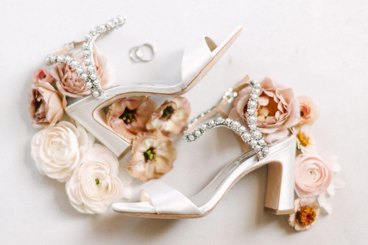 bride's shoes surrounded by flowers