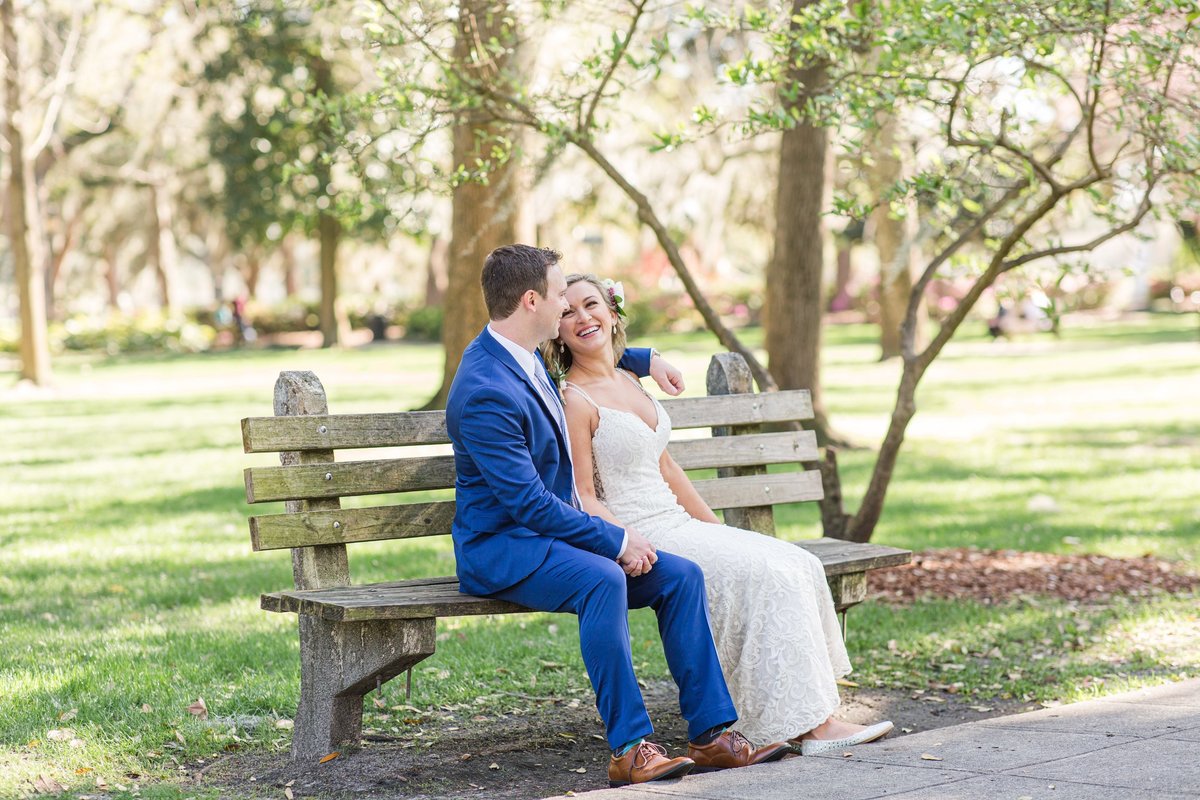 bride and groom on bench in forsyth park