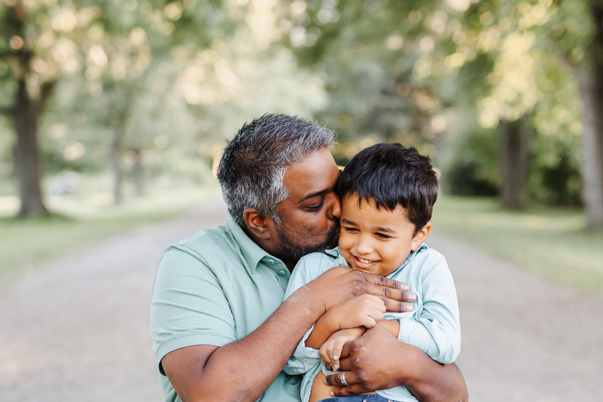 Dad give his son some love during his photoshoot at the Guelph Arboretum.
