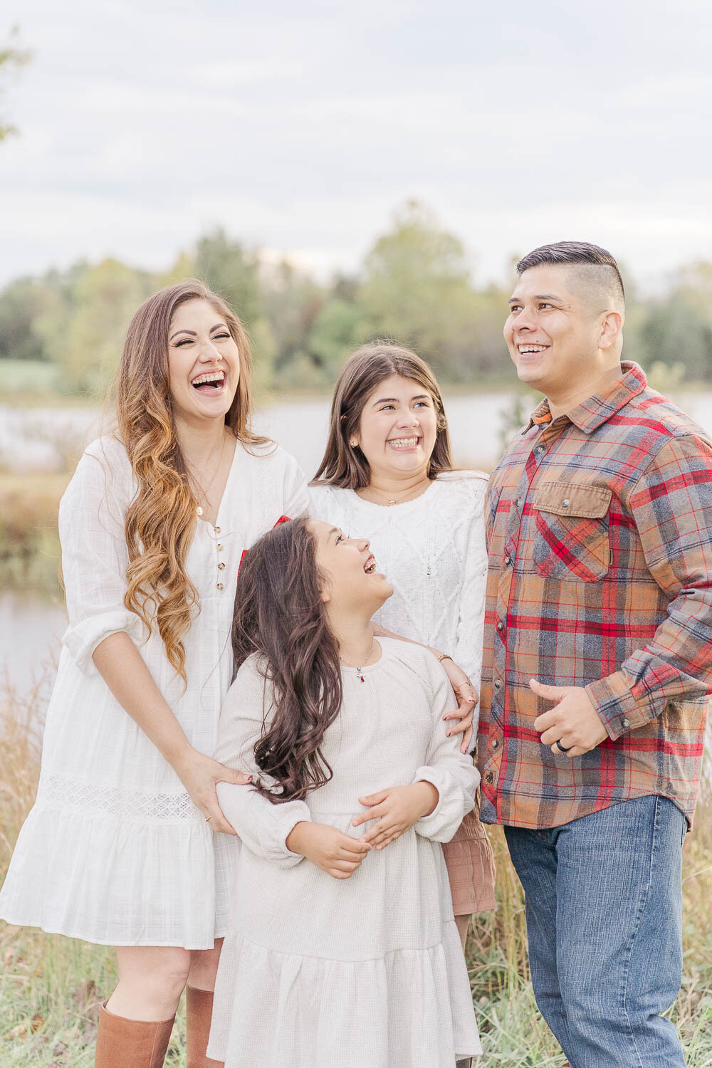 family of 4 laughing during fall minis in Manassas, VA