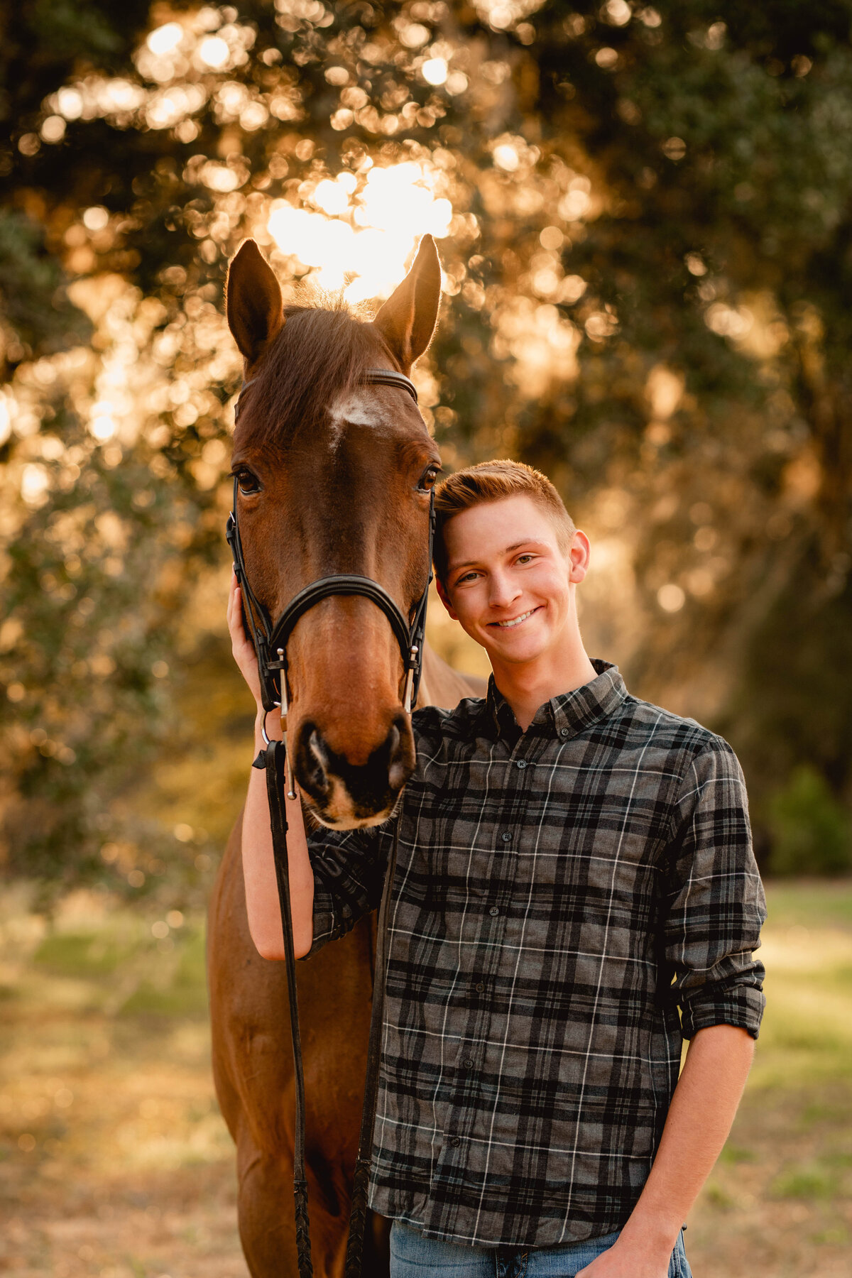 Senior boy takes photos with his gelding at Cavallo Farms near Tallahassee, Florida.