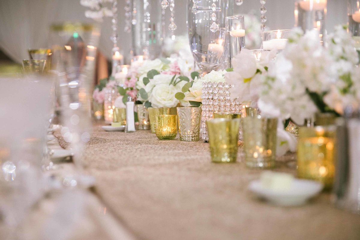 Wedding reception table scape with white hydrangea and gold candles