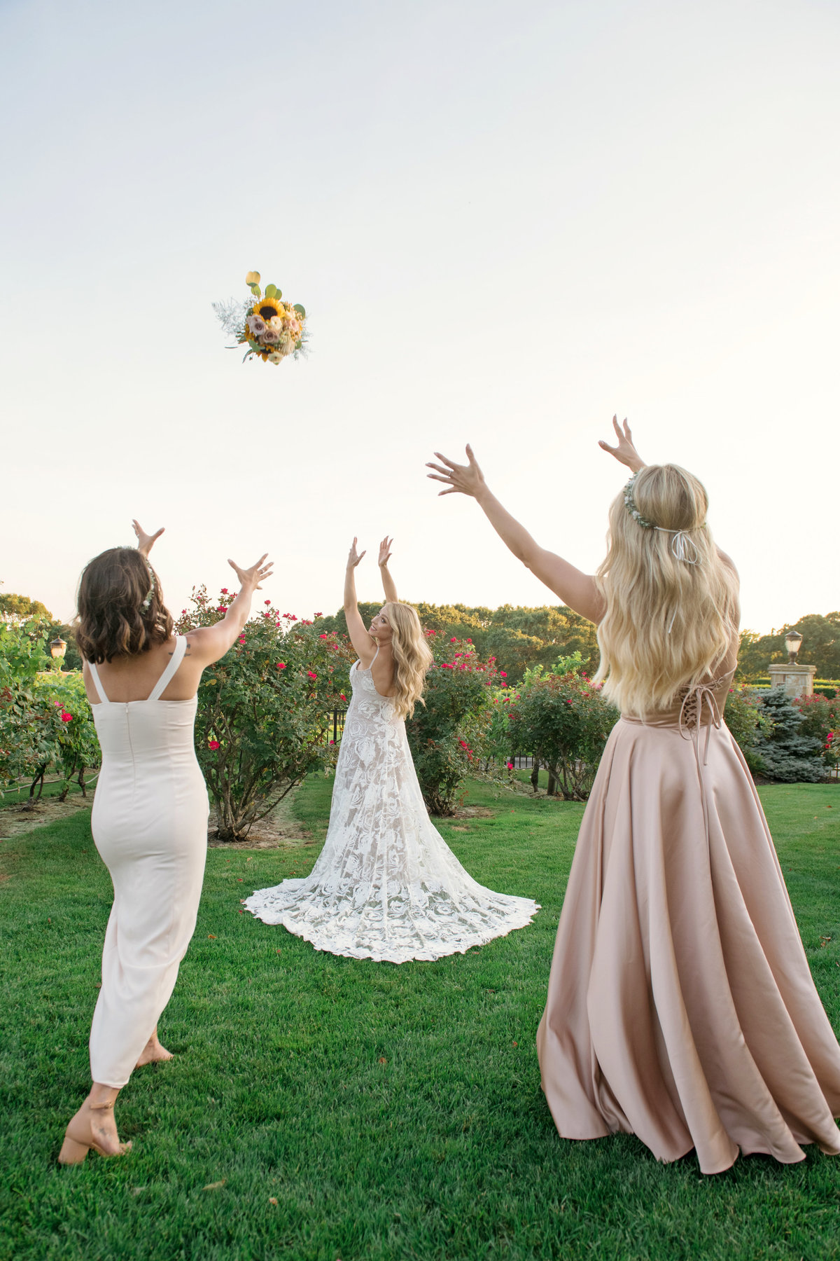 bride tossing bouquet outside Giorgios Baiting Hollow