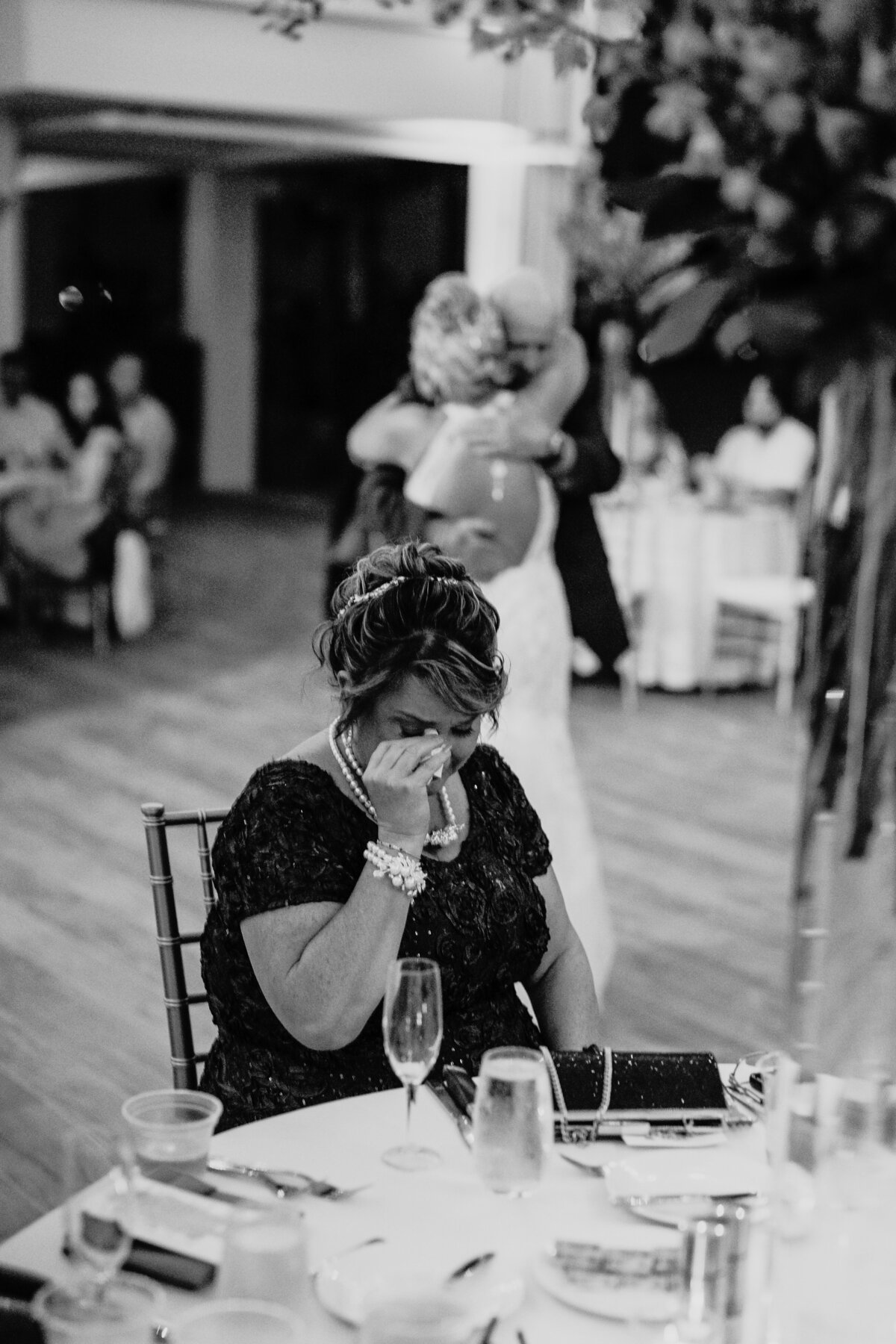 mother of bride crying during father daughter dance at repcetion
