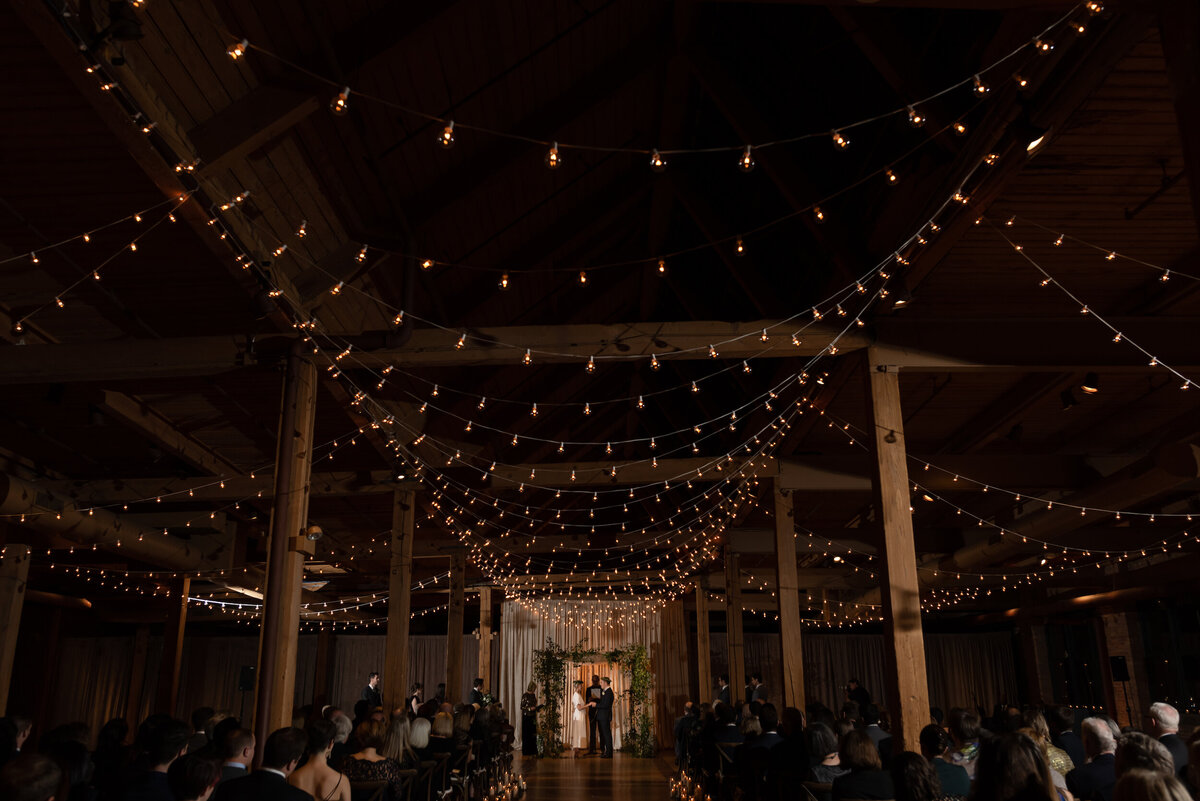 String lights cover the ceiling during a jewish wedding ceremony at Bridgeport Arts Center in Chicago, Illinois