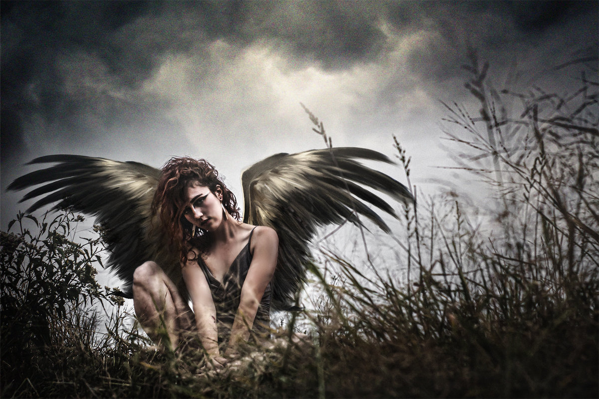 Fantasy  photo of a winged woman in the grass near Occoquan VA