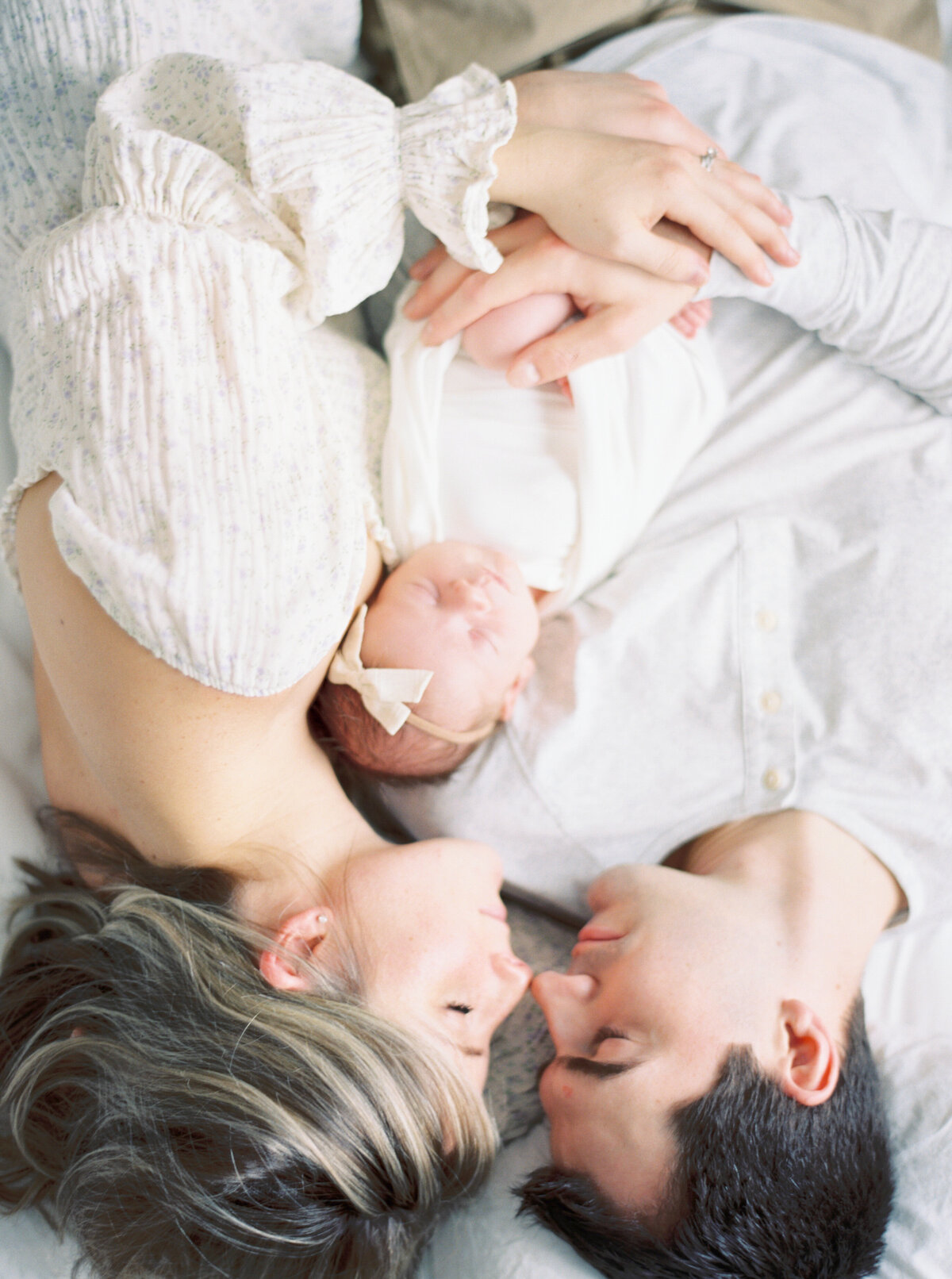 new parents holding newborn baby girl in studio by newborn photography milwaukee wi talia laird photography