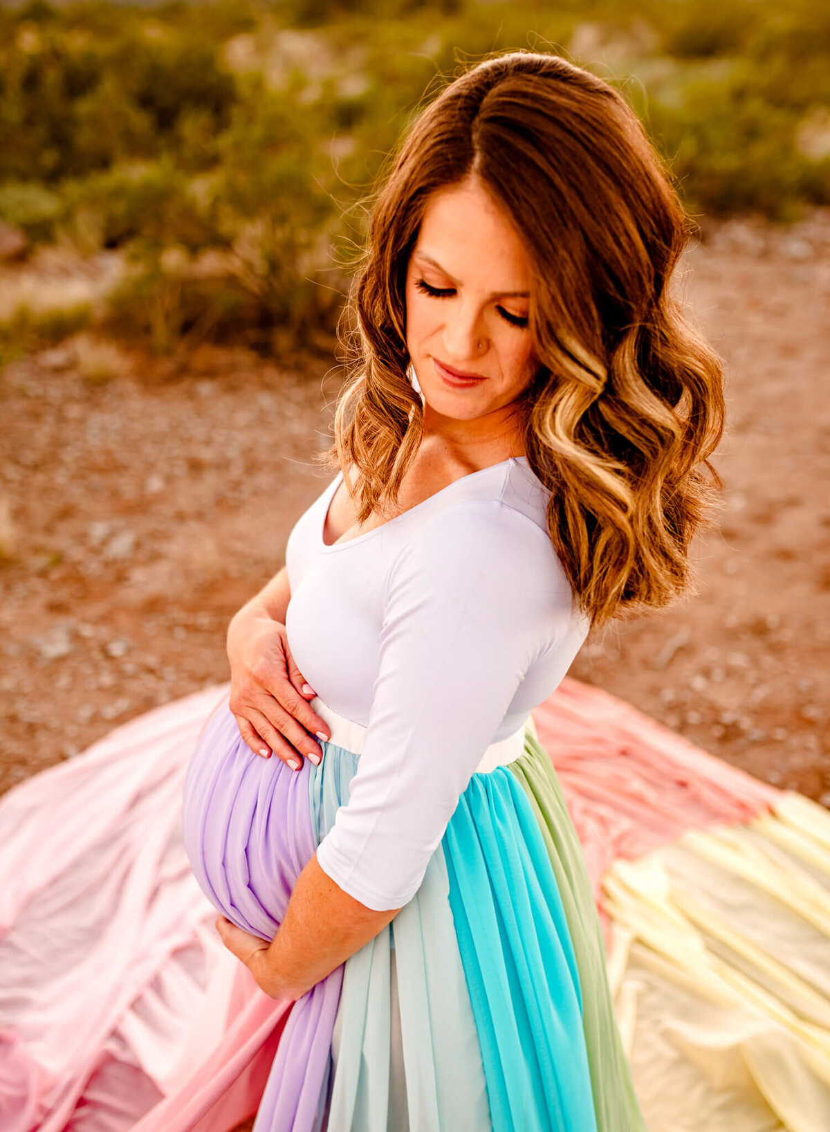 photograph of AZ mom looking down while holding maternity bump