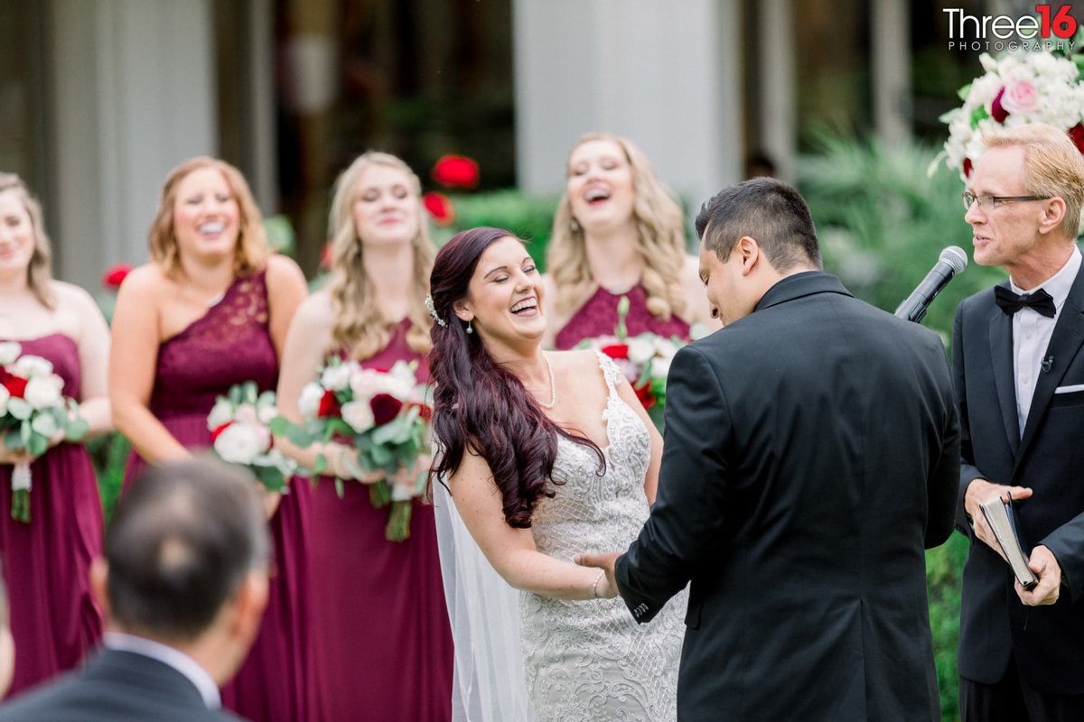 Bride and Bridesmaid start laughing during the ceremony