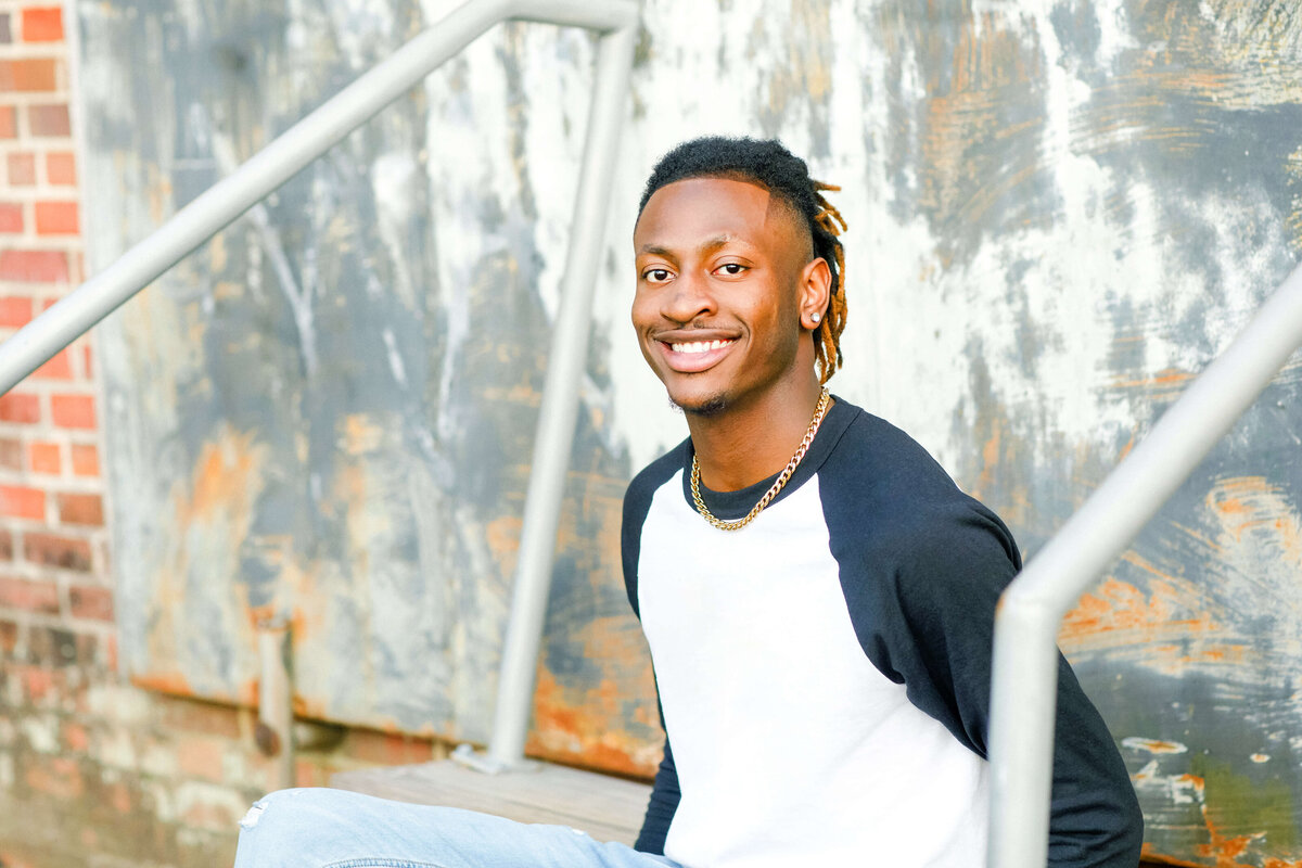 high school senior sitting on stairs for senior photoshoot