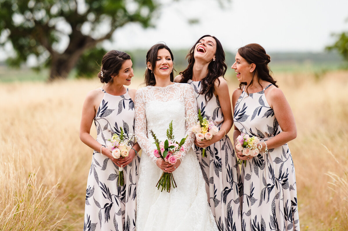 Bride with her bridesmaids laughing