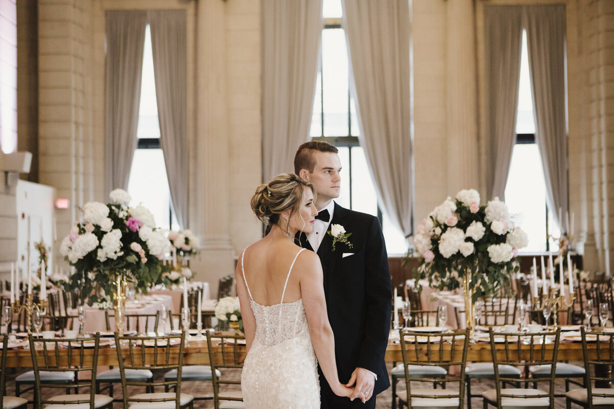 Bride and groom embracing in wedding reception room in Buffalo, New York