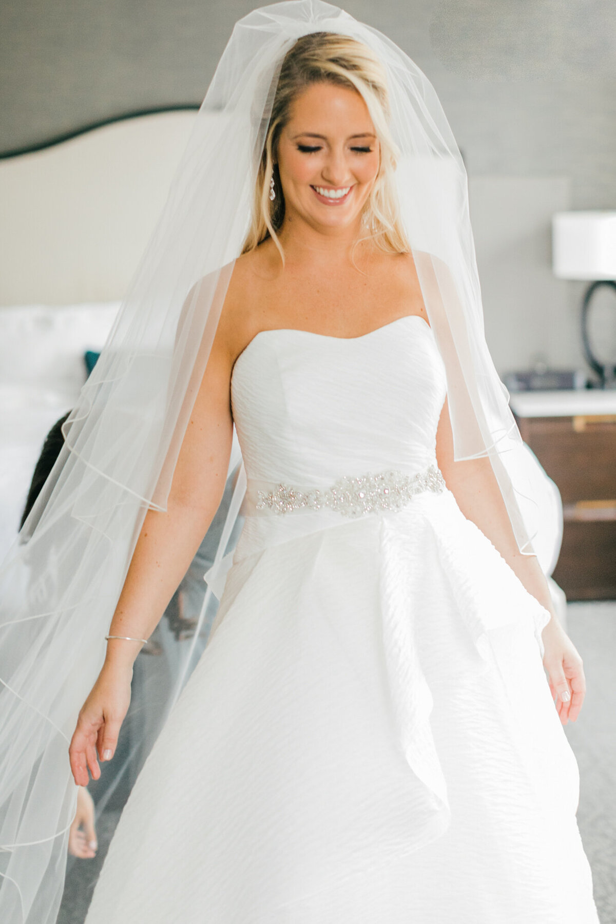 A beautiful bride smiles as she gets ready for her wedding day in Chicago