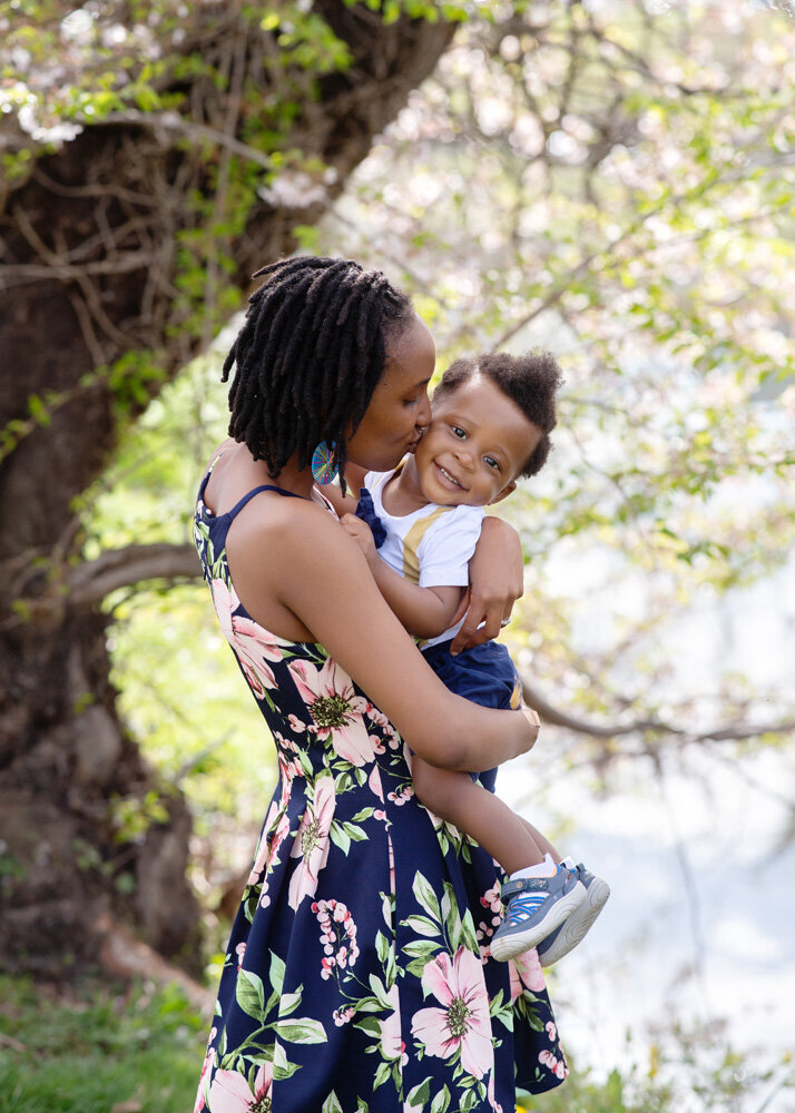 Family session of little boy and his mother in a floral dress