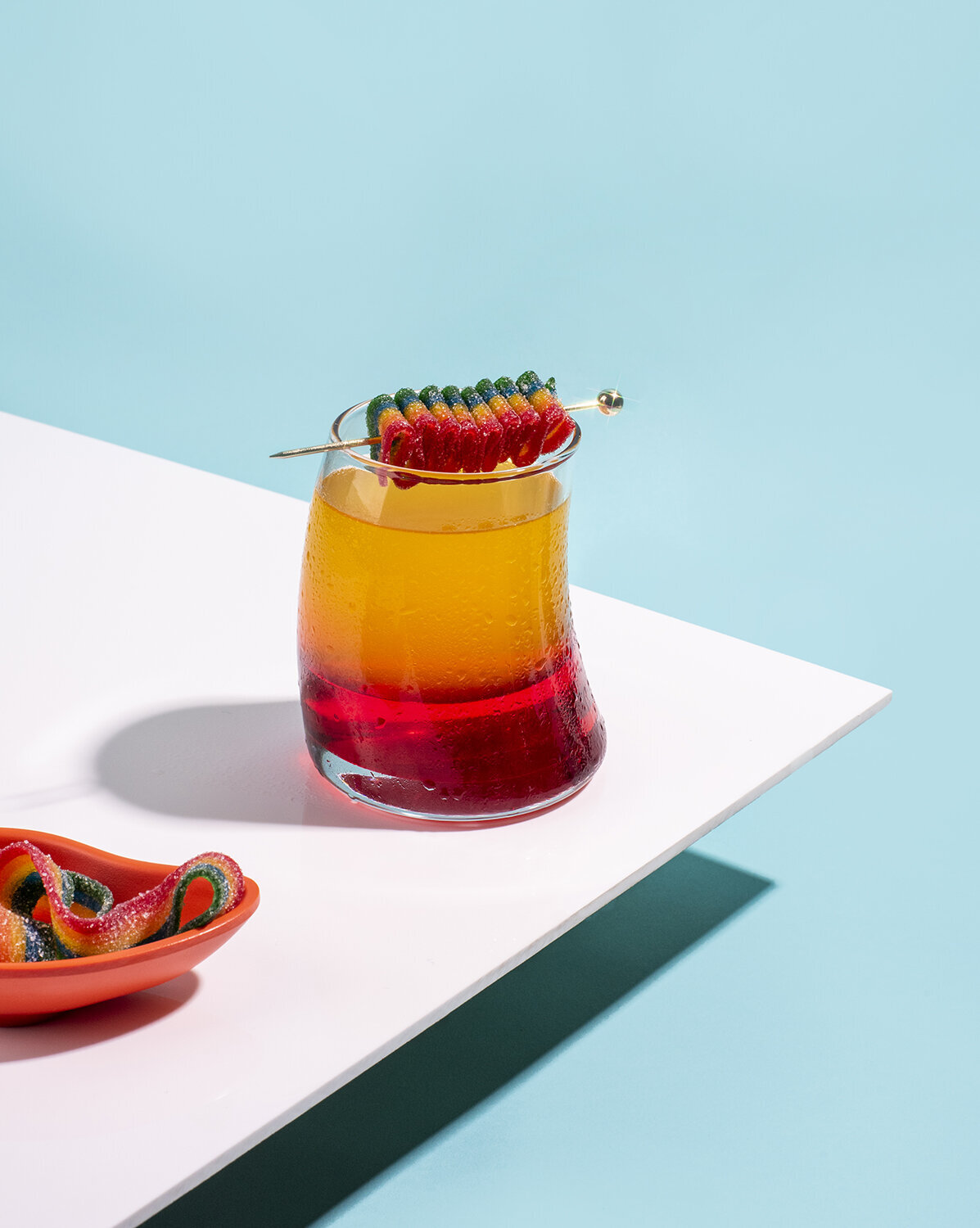 multicolored cocktail photography on blue background